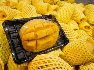 Organic Yellow ripe mango in package at supermarket.