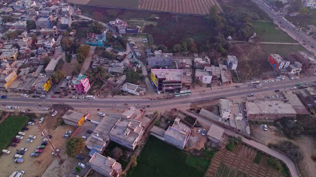 bird eye view shot of ayodhya dham road with Independent houses and farming land at day time, tracking shot, drone shot, 4k.
