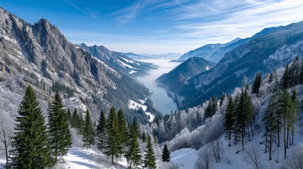 Obraz premium Breathtaking Sunrise Over Snowy Mountains with Tranquil Lake and Fog-Covered Valley: A Perfect Escape into Nature