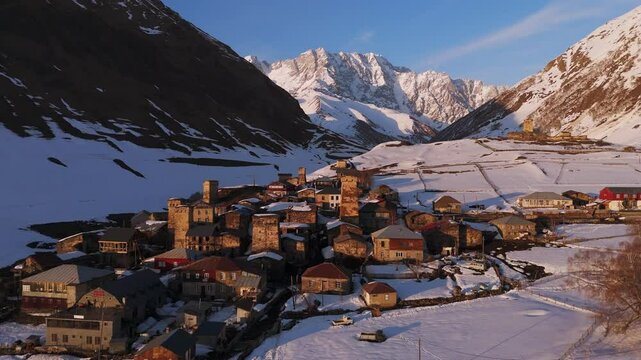 The Mountain Village Of Ushguli With The Shkhara Peak In The Background During Sunset In Svaneti, Georgia. Aerial Pullback Shot