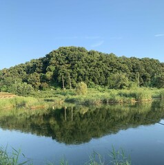  Tranquil Lake and Hill Under Clear Blue Sky