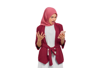 Angry young Asian Muslim woman in hijab expressing frustration while using smartphone isolated on transparent background