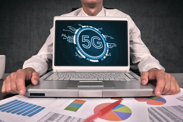 Businessman using laptop with 5G network internet mobile wireless interface