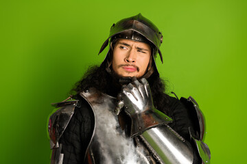 Confident knight in shiny armor standing against a bold green backdrop conveying historical charm...