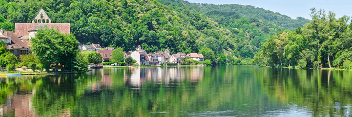Panorama of the village of Beaulieu-sur-Dordogne and the Dordogne river in Corrèze Nouvelle-Aquitaine in Southern France on a sunny day in summer	