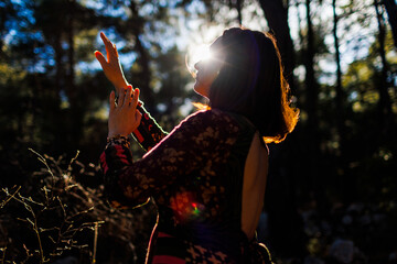 Portrait of a young beautiful dancer practicing intently among natural landscapes. A young and...