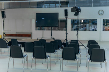 Conference Room with Empty Chairs and Small Stage