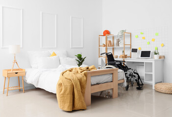 Obraz premium Interior of student's bedroom with wheelchair and table