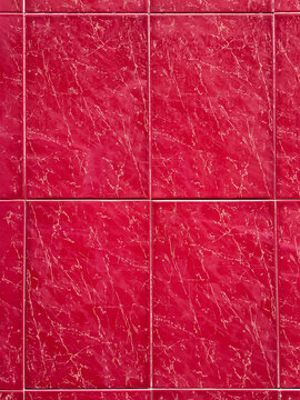 Red marble tiles with natural veining pattern