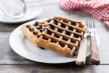 Belgian Waffles with chocolate on wooden table