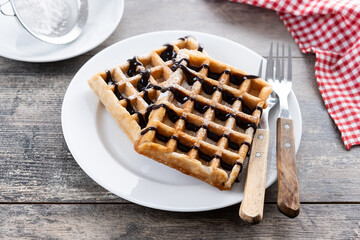 Belgian Waffles with chocolate on wooden table