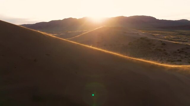 Dune on a sunset, windy weather, drone view