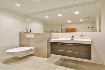Sleek and contemporary bathroom featuring minimalist design elements, stylish fixtures, and ample lighting creating an inviting space.