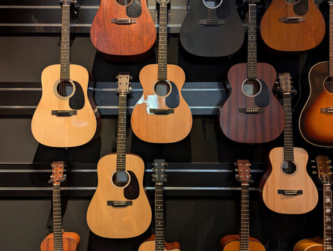 Wall display of acoustic guitars in music store