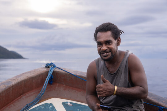 Local native man on a boat in Kri Island, Raja Ampat, Indonesia