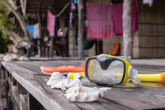 Diving equipment on wooden dock at Kri Island, Raja Ampat