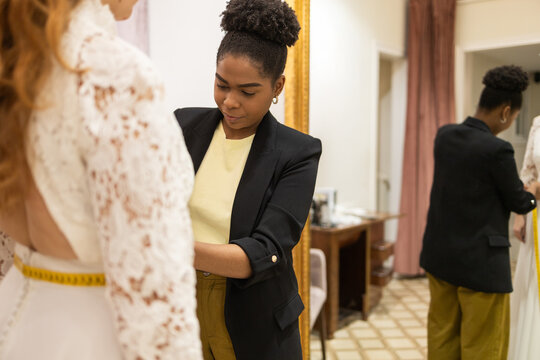Seamstress Adjusting Lace Dress in Tailor Studio