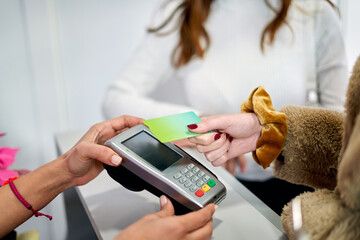 Customer Making Contactless Payment at Beauty Salon Counter