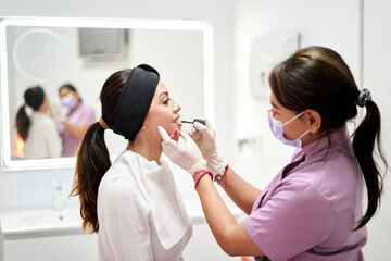Beauty Therapist Applying Lip Color During Client Makeup Session