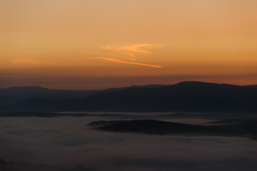 Early dawn in the hilly area. Lots of morning fog among the hills.