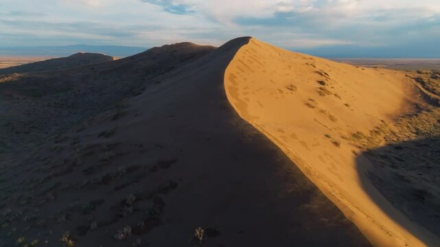 Dune on a sunset, windy weather, drone view