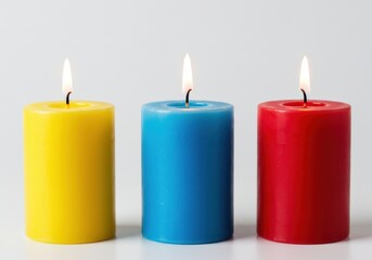 Three colorful candles burning isolated on white background