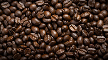 Fototapeta premium Top view background of aromatic brown coffee beans scattered on surface