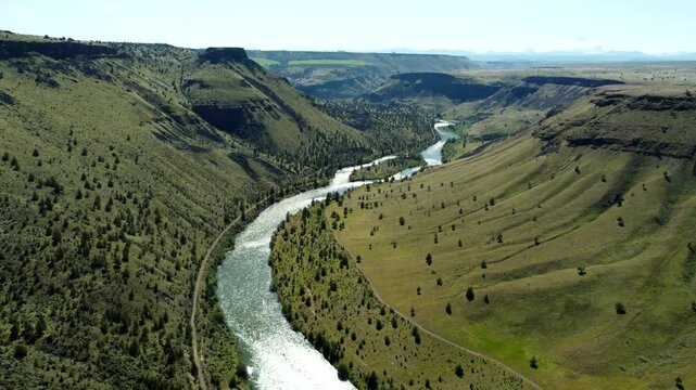 US, Oregon, Madras, Trout Creek Campground, 2025-04-19 - Drone view flying in the canyon of the Deschutes River at Trout Creek in central Oregon. In spring at a high river flow.