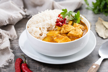 Massaman curry in bowl on wooden table. Traditional Thai food recipe.