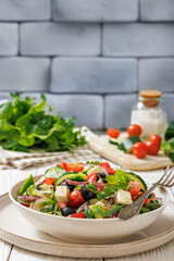 greek salad of veggies, olives, cheese in bowl