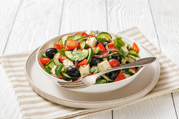 greek salad of veggies, olives, cheese in bowl