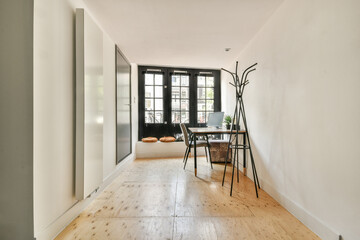 A well-designed modern interior featuring natural light, wooden flooring, and minimalist furniture, ideal for contemporary living spaces.