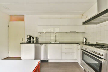 A sleek, modern kitchen showcasing stainless steel appliances, minimalist cabinetry, and an open layout that maximizes space and functionality.