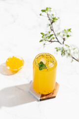 tropical Bubble Tea, Isolated on White Background. Colorful, Fresh Orange Boba Drink with Fruit Fizzy Jellies and Ice Cubes. Tapioca pearls. 