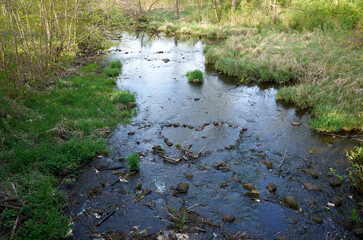 Body of water with a heart shape drawn in the mud