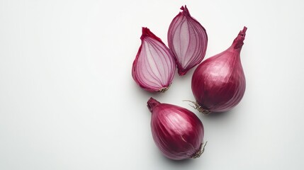 Fototapeta premium Fresh red onions, sliced and whole, on a white background