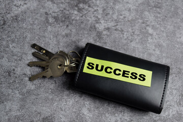 Concept of Key to success write on sticky notes isolated on Wooden Table.