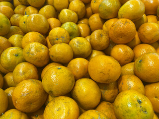 Portrait Shot of Fresh Malang Oranges Stacked in Traditional Market Display