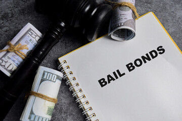 Concept of Bail Bonds write on book isolated on Wooden Table.