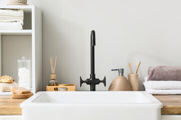 Bath accessories near modern sink in bathroom