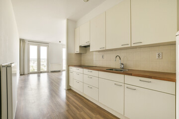 Bright and spacious kitchen featuring minimalist design with sleek cabinetry and natural light enhancing the open layout.