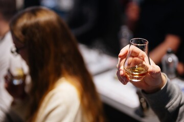 Enjoying whiskey tasting at a cozy bar with friends in the evening