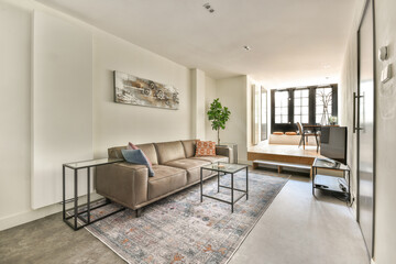 A contemporary living room featuring stylish furniture, natural light, and elegant decor, creating a cozy and inviting atmosphere.