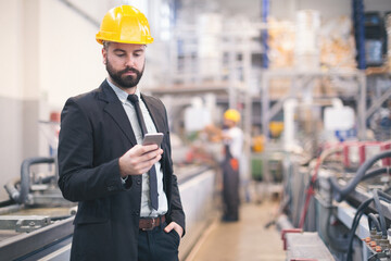 Quality inspectors team and workers at factory using machines