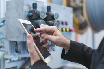 Quality inspectors team and workers at factory using machines