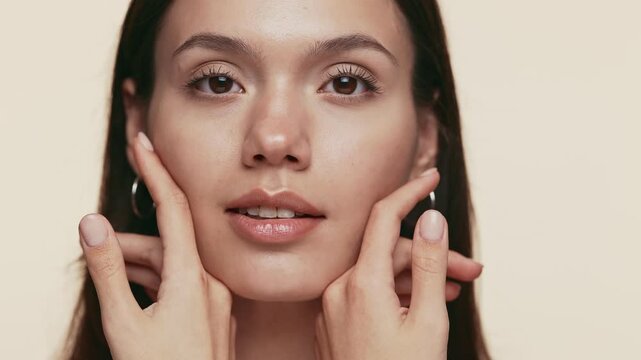 A close-up image capturing the concept of beauty through a person delicately touching their own clear and smooth skin.