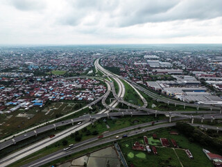 Aerial view of urban highway interchange with dense housing and industry