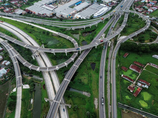 Aerial view of urban highway interchange with dense housing and industry