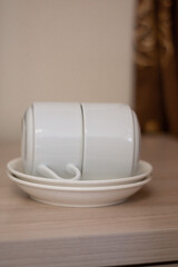 Two cups lie on two saucers. Tea Pairs