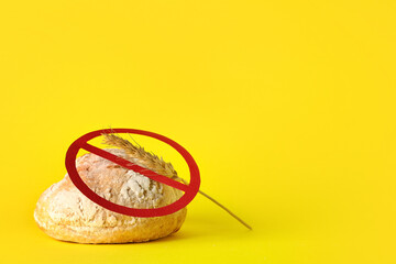 Bread with spikelet and stop sign on yellow background. Food Allergy Awareness Month